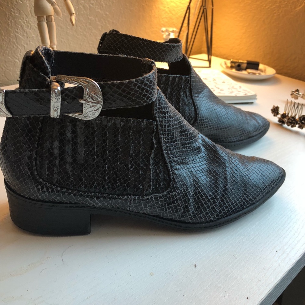 Black snakeskin pointed toe boots